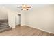 Cozy living room with carpeted stairs and wood-look flooring, filled with natural light at 3049 Historic Horizon Ave, Henderson, NV 89044