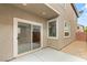 View of backyard patio area with sliding glass door, gravel, and brick wall at 3049 Historic Horizon Ave, Henderson, NV 89044