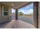 Covered back patio offers stone columns, paving stones, and views of the landscaped backyard area at 31 Strada Loreto, Henderson, NV 89011