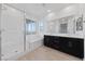 Bright bathroom features a shower with a glass door, bathtub, and vanity with dual sinks at 31 Strada Loreto, Henderson, NV 89011
