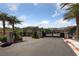 Gated community entrance with lush landscaping, providing security and curb appeal for residents at 31 Strada Loreto, Henderson, NV 89011