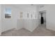 Bright hallway features neutral carpet, white walls, natural light, and an open doorway to a bedroom at 31 Strada Loreto, Henderson, NV 89011