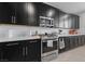 A well-appointed kitchen featuring sleek black cabinetry, stainless steel appliances, and stylish countertops at 31 Strada Loreto, Henderson, NV 89011