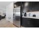 Features a stainless steel refrigerator and matching black cabinets with updated hardware at 31 Strada Loreto, Henderson, NV 89011