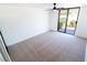 Bright bedroom features plush carpeting, a ceiling fan, and large glass doors at 3140 Pradera Cir, Las Vegas, NV 89121
