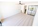 Bright bedroom features plush carpeting, ceiling fan, and sliding closet doors at 3140 Pradera Cir, Las Vegas, NV 89121
