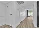 Hallway with wood floors leads to a bright room with fireplace and large glass doors at 3140 Pradera Cir, Las Vegas, NV 89121
