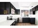 Modern kitchen with black cabinets, stainless steel appliances and lots of natural light at 3140 Pradera Cir, Las Vegas, NV 89121