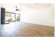 Spacious living room featuring wood flooring, natural light, and a cozy fireplace at 3140 Pradera Cir, Las Vegas, NV 89121