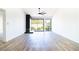 Spacious living room with wood flooring, fireplace, and sliding doors at 3140 Pradera Cir, Las Vegas, NV 89121