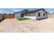The backyard features a freshly manicured small lawn, an exterior door, and a private setting at 3330 Rio Grande St, Las Vegas, NV 89115