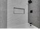 Stylish bathroom featuring modern tile work, shower head, and convenient recessed shelving for a clean and organized space at 3330 Rio Grande St, Las Vegas, NV 89115