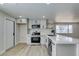 A bright, modern kitchen featuring white cabinetry, quartz countertops, and stainless steel appliances at 3330 Rio Grande St, Las Vegas, NV 89115