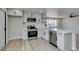 Bright kitchen features white cabinets, stainless steel appliances, and a functional island for meal preparation at 3330 Rio Grande St, Las Vegas, NV 89115