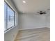 Spacious living room showcasing hardwood floors, a contemporary ceiling fan, and ample natural light at 3330 Rio Grande St, Las Vegas, NV 89115