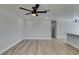 Bright, open-concept living room with a ceiling fan, fresh paint, and wood floors, perfect for relaxation and entertaining at 3330 Rio Grande St, Las Vegas, NV 89115
