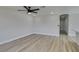 Open-concept living room with wood floors, ceiling fan, freshly painted walls, and access to the kitchen at 3330 Rio Grande St, Las Vegas, NV 89115