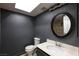 Bathroom with a round mirror, vanity with a sink, and toilet at 3719 Centennial Cir, Las Vegas, NV 89121