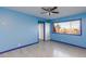 Blue bedroom with a window providing natural light, and a door into another room at 3719 Centennial Cir, Las Vegas, NV 89121