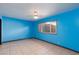 Bright bedroom with tiled flooring, a ceiling fan, and a large window allowing ample natural light at 3719 Centennial Cir, Las Vegas, NV 89121