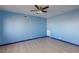 Bright bedroom with blue walls, wood-look flooring and a modern ceiling fan at 3719 Centennial Cir, Las Vegas, NV 89121