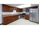 Traditional kitchen featuring stainless steel appliances, wooden cabinets, and tile flooring at 3719 Centennial Cir, Las Vegas, NV 89121