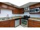 The kitchen features stainless steel appliances, wood cabinets, and granite countertops at 3719 Centennial Cir, Las Vegas, NV 89121