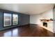 The living room features hardwood floors, large windows, and a stone fireplace at 3719 Centennial Cir, Las Vegas, NV 89121