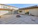 A spacious patio with a fire pit and stucco walls, perfect for outdoor entertaining at 3719 Centennial Cir, Las Vegas, NV 89121