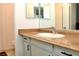 Bathroom with a sleek sink, vanity, mirror, and toilet behind a shower curtain at 3740 Desert Marina Dr # 11, Laughlin, NV 89029