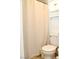 Bathroom featuring a toilet, shower curtain, and overhead storage at 3740 Desert Marina Dr # 11, Laughlin, NV 89029