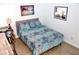 Comfortable bedroom with patterned bedding, a wooden desk, and a decorative wall mirror at 3740 Desert Marina Dr # 11, Laughlin, NV 89029