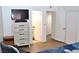 Bedroom featuring a large dresser with a TV, open access to the bathroom, and spacious closet at 3740 Desert Marina Dr # 11, Laughlin, NV 89029