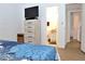 Bedroom featuring a large dresser with a TV, open access to the bathroom, and spacious closet at 3740 Desert Marina Dr # 11, Laughlin, NV 89029