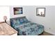 Comfortable bedroom with patterned bedding, a wooden desk, and a decorative wall mirror at 3740 Desert Marina Dr # 11, Laughlin, NV 89029