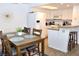 Dining area leading to a bright kitchen with bar-style seating and white appliances at 3740 Desert Marina Dr # 11, Laughlin, NV 89029