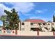 View of condo's exterior and stairs to the second level with a red tile roof at 3740 Desert Marina Dr # 11, Laughlin, NV 89029