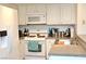 Bright kitchen with white appliances, ample storage, and efficient layout at 3740 Desert Marina Dr # 11, Laughlin, NV 89029