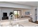 A cozy living room features a tan couch, a view of the balcony and patio, and a flat screen tv at 3740 Desert Marina Dr # 11, Laughlin, NV 89029