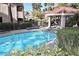 Relax in the community pool surrounded by lush greenery and a shaded gazebo area at 3740 Desert Marina Dr # 11, Laughlin, NV 89029