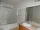 Bathroom features a tub-shower combo with sliding glass doors and a single sink vanity at 3890 Terrazzo Ave, Las Vegas, NV 89115