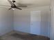 Bedroom features a ceiling fan and a white door, offering a simple and functional space at 3890 Terrazzo Ave, Las Vegas, NV 89115