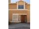 Inviting entrance to stucco townhome with an open door, security windows, and covered porch at 3890 Terrazzo Ave, Las Vegas, NV 89115