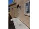 Side view of a storage area with a locked door, bars on the window and a textured wall at 3890 Terrazzo Ave, Las Vegas, NV 89115