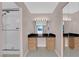 Bathroom vanity with black countertop and shower with glass door at 3930 University Center Dr # 202, Las Vegas, NV 89119