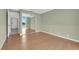 Bedroom with hardwood floors, green walls, and mirrored closet at 3930 University Center Dr # 202, Las Vegas, NV 89119