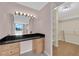 Walk-in closet with custom built-in cabinets, granite vanity top, and shelving at 3930 University Center Dr # 202, Las Vegas, NV 89119