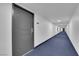 Hallway to apartments with dark gray doors at 3930 University Center Dr # 202, Las Vegas, NV 89119