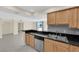 View of kitchen with stainless dishwasher, tile floors, double sinks, and breakfast bar at 3930 University Center Dr # 202, Las Vegas, NV 89119