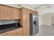 Bright kitchen featuring wood cabinets, stainless refrigerator, and stone countertops at 3930 University Center Dr # 202, Las Vegas, NV 89119